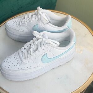 Nike Women’s White Leather Sneakers with Light Blue Swoosh Accent